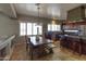 Charming kitchen with a wooden table next to the island and natural light from the windows at 9548 W Keyser Dr, Peoria, AZ 85383