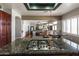 Modern kitchen with dark granite countertops, stainless steel appliances and open concept to other living areas at 9548 W Keyser Dr, Peoria, AZ 85383