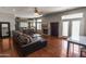 Open-concept living room with a large sofa, fireplace, and dining area, perfect for entertaining at 9548 W Keyser Dr, Peoria, AZ 85383