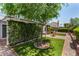 Beautifully landscaped backyard showcasing mature trees and manicured hedges at 9636 N 53Rd Ave, Glendale, AZ 85302