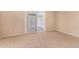Bedroom with tan carpet and sliding glass door at 9636 N 53Rd Ave, Glendale, AZ 85302