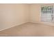 Bedroom featuring a window and tan carpet at 9636 N 53Rd Ave, Glendale, AZ 85302