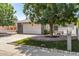 Inviting home exterior with a well-kept lawn, mature trees, and an attached garage at 9636 N 53Rd Ave, Glendale, AZ 85302