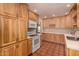 Fully equipped kitchen with white appliances, warm wood cabinetry, and tile flooring at 9636 N 53Rd Ave, Glendale, AZ 85302