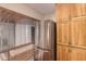Efficient kitchen design with wood cabinets and stainless steel refrigerator at 9636 N 53Rd Ave, Glendale, AZ 85302