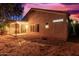 Exterior of home with a covered patio and spacious backyard, creating a tranquil retreat at 10735 W Bermuda Dr, Avondale, AZ 85392
