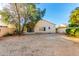 Spacious backyard with mature trees and concrete patio, ideal for entertaining and outdoor activities at 10735 W Bermuda Dr, Avondale, AZ 85392