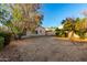 Expansive backyard featuring mature trees, patio, and a blank canvas for outdoor enjoyment at 10735 W Bermuda Dr, Avondale, AZ 85392