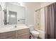 Well-lit bathroom features a single sink vanity with white cabinets and a shower-tub combo at 10735 W Bermuda Dr, Avondale, AZ 85392