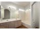 Bright bathroom with double sinks, large mirror, tub and tile surround at 10735 W Bermuda Dr, Avondale, AZ 85392