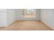 A simple bedroom with carpet, window, and baseboard with white wall at 10735 W Bermuda Dr, Avondale, AZ 85392