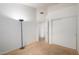 A simple bedroom with carpet, lamp, and baseboard with white wall and closet at 10735 W Bermuda Dr, Avondale, AZ 85392