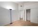A simple bedroom with carpet, lamp, and baseboard with white wall and closet at 10735 W Bermuda Dr, Avondale, AZ 85392