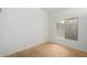 A simple bedroom with carpet, window, and baseboard with white wall at 10735 W Bermuda Dr, Avondale, AZ 85392