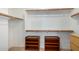 Walk-in closet with shelves, wooden racks, and ample storage space at 10735 W Bermuda Dr, Avondale, AZ 85392