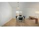 Dining room with neutral carpet, glass table, and view to entryway at 10735 W Bermuda Dr, Avondale, AZ 85392