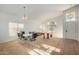 Spacious dining area featuring neutral carpet, large windows, and a glass dining table at 10735 W Bermuda Dr, Avondale, AZ 85392