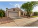 Inviting home boasts a two-car garage, low maintenance desert landscaping, and neutral color palette at 10735 W Bermuda Dr, Avondale, AZ 85392