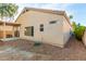 Exterior view featuring a covered patio and spacious yard with low-maintenance landscaping at 10735 W Bermuda Dr, Avondale, AZ 85392
