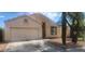 Charming single-story home with a two-car garage, desert landscaping, and a welcoming facade at 10735 W Bermuda Dr, Avondale, AZ 85392
