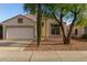 Well-maintained single-story home with a two-car garage and desert landscaping at 10735 W Bermuda Dr, Avondale, AZ 85392