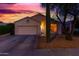 Single-story home featuring desert landscaping, a two-car garage and classic southwestern architecture at 10735 W Bermuda Dr, Avondale, AZ 85392