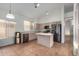 Bright kitchen featuring stainless steel appliances, center island, and light-colored cabinets at 10735 W Bermuda Dr, Avondale, AZ 85392