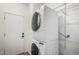 A stacked washer and dryer set is featured with metal shelving at 10735 W Bermuda Dr, Avondale, AZ 85392