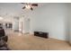 Large living room with neutral walls, carpet, and an entertainment center against the wall at 10735 W Bermuda Dr, Avondale, AZ 85392