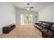 Bright living room with vaulted ceiling, ceiling fan, and sliding glass doors to backyard at 10735 W Bermuda Dr, Avondale, AZ 85392