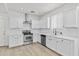 Modern kitchen with white cabinetry, stainless steel appliances and fixtures, and wood-style flooring at 1225 N 36Th St # 1015, Phoenix, AZ 85008