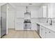 Beautiful, modern kitchen with stainless steel appliances, white cabinets, and wood flooring at 1225 N 36Th St # 1015, Phoenix, AZ 85008