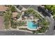 Aerial view of community pool area with mature landscaping, seating and clubhouse at 1225 N 36Th St # 1015, Phoenix, AZ 85008