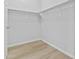 Bright walk-in closet with wood-look tile floors and rod and shelf storage system at 1225 N 36Th St # 1015, Phoenix, AZ 85008