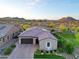 Beautiful aerial view of the home featuring mature landscaping, a brick driveway, and solar panels on the roof at 13236 W Montansoro Ln, Peoria, AZ 85383