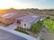 Scenic aerial view of the home with solar panels, showcasing the backyard design and surrounding landscape at 13236 W Montansoro Ln, Peoria, AZ 85383