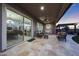 Covered patio with travertine flooring, comfortable seating, and a cozy swing at 13236 W Montansoro Ln, Peoria, AZ 85383