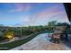 Cozy back patio featuring a comfortable chair and lush desert landscaping at 13236 W Montansoro Ln, Peoria, AZ 85383