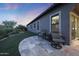 Relaxing outdoor space with cushioned seating and manicured desert landscaping at twilight at 13236 W Montansoro Ln, Peoria, AZ 85383