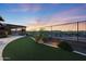 Backyard with a built-in grill, turf and desert landscaping at 13236 W Montansoro Ln, Peoria, AZ 85383