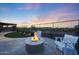 Backyard features a built-in grill, fire pit, turf and desert views at 13236 W Montansoro Ln, Peoria, AZ 85383