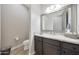 Elegant powder room featuring a granite countertop, sleek fixtures and modern finishes at 13236 W Montansoro Ln, Peoria, AZ 85383