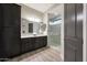Modern bathroom featuring dual sinks, granite countertops and a glass enclosed shower at 13236 W Montansoro Ln, Peoria, AZ 85383