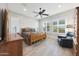 Bright bedroom featuring a ceiling fan and plenty of natural light from the shuttered windows at 13236 W Montansoro Ln, Peoria, AZ 85383