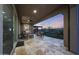 Large covered patio with comfortable seating, swing and travertine flooring at 13236 W Montansoro Ln, Peoria, AZ 85383