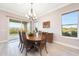 Dining room with backyard views, chandelier, and sliding glass door access to patio at 13236 W Montansoro Ln, Peoria, AZ 85383