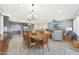 Dining room table with kitchen island, living room and backyard views at 13236 W Montansoro Ln, Peoria, AZ 85383