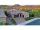 Home with a three-car garage, desert landscaping, and mountain views at 13236 W Montansoro Ln, Peoria, AZ 85383