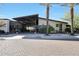Exterior view of the modern Mita Club building with desert landscaping and palm trees in a sunny neighborhood at 13236 W Montansoro Ln, Peoria, AZ 85383
