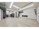 Spacious garage featuring epoxy flooring, overhead storage racks and ample space for vehicles at 13236 W Montansoro Ln, Peoria, AZ 85383